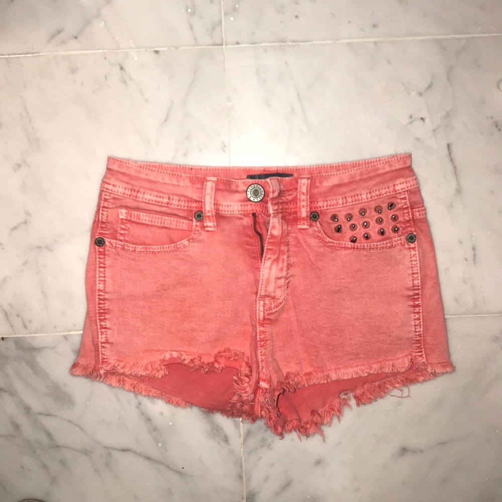 Red washed out jean shorts with silver spikes